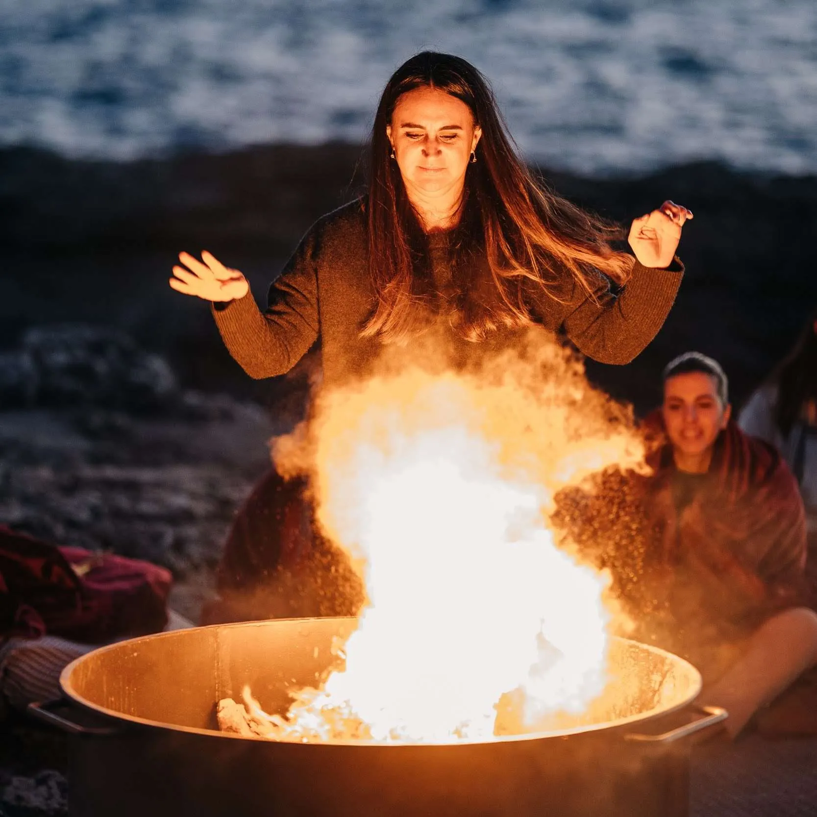 Fire ceremony on the beach at sunset